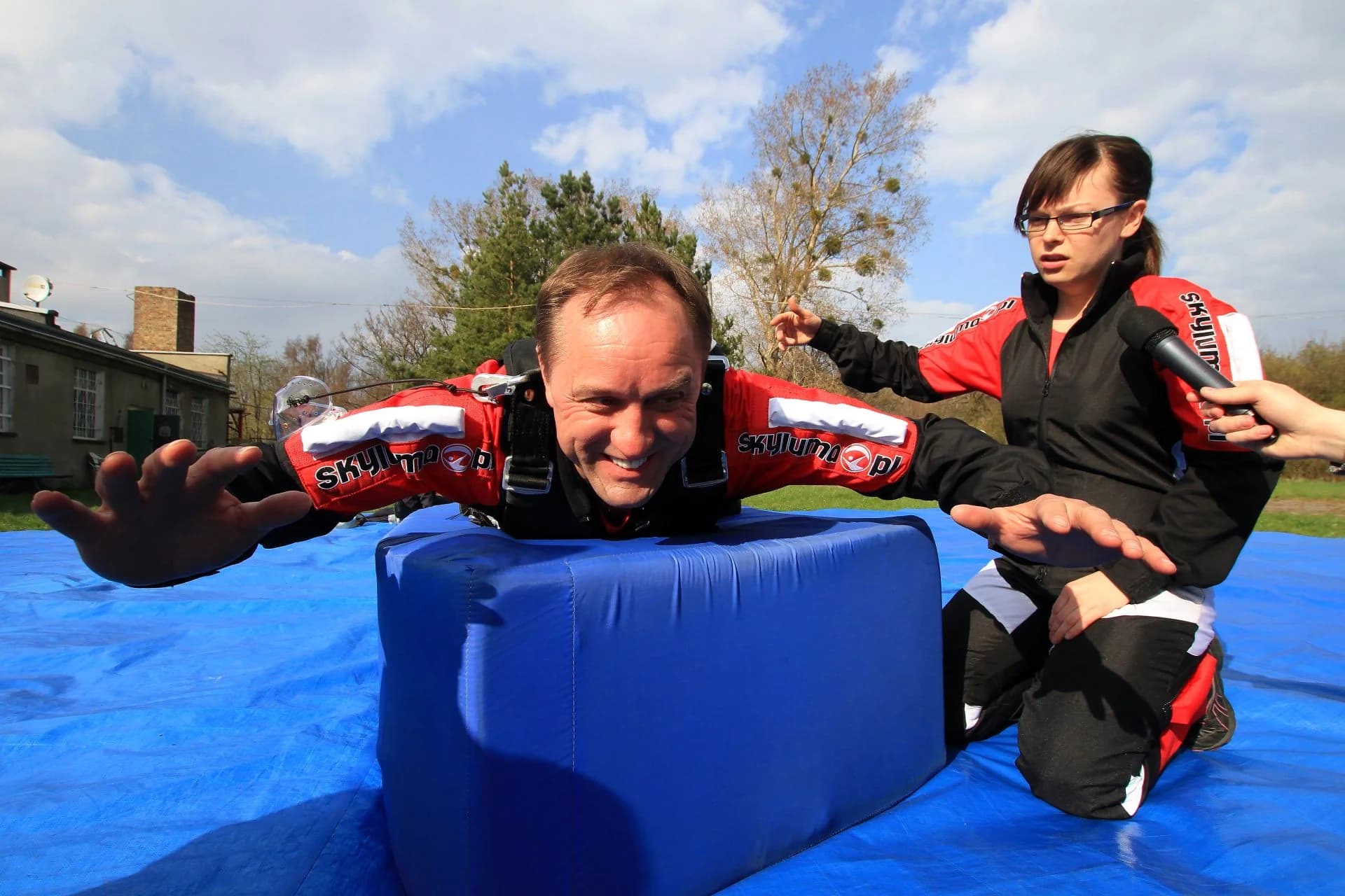 Practising the freefall arch on the mattress — still on the ground, before the flight